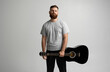 © Volodymyr - Portrait of handsome young bearded musician, guitar player standing with acoustic guitar in a hand with white wall on background.