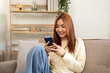 © Katcha - Young woman lesbian using smartphone to chatting with friends an
