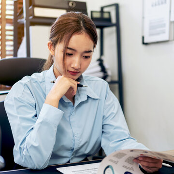 Businesswoman is thoughtful about accounting of business while r
