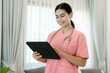 © visoot - Portrait of female caregiver at patient home.