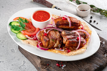 Wall Mural - Pieces of pork kebab on a plate with pita bread and fresh vegetables. Grilled Pork Dishes