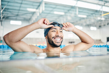 Happy, man or relax in swimming pool with cap or goggles in sports wellness, training or exercise in body muscle. Workout, fitness or swimmer athlete with smile, water competition goals or healthcare