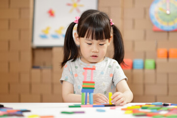 Wall Mural - young girl play number sticks fine motor skill game for homeschooling