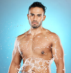 Poster - Portrait, splash and beauty, skin and skincare man cleaning his body, muscle and topless. Water, male and wellness model with moisture, cosmetic and hydration isolated in studio blue background