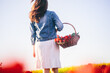 © Photocreo Bednarek - Woman with flowers in the basket on tulip field in spring