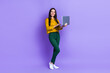 © deagreez - Full size photo of pretty cheerful girl hold use wireless netbook coworking isolated on violet color background