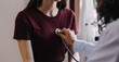 © ARMMY PICCA - Homecare nursing service and elderly people cardiology healthcare. Close up of young hispanic female doctor nurse check mature caucasian man patient heartbeat using stethoscope during visit