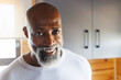 © Wavebreak Media - Close-up portrait of smiling african american bald senior man enjoying holiday in log cabin