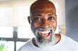 © Wavebreak Media - Close-up portrait of cheerful bald african american senior man laughing in log cabin
