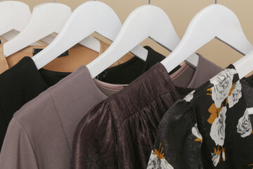 Wall Mural - Women's Clothes. Close up image of clothes rack with stylish and elegant clothes in fashion atelier. Minimalist fashion blog concept.