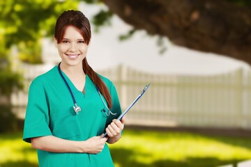 Wall Mural - Happy young female doctor posing