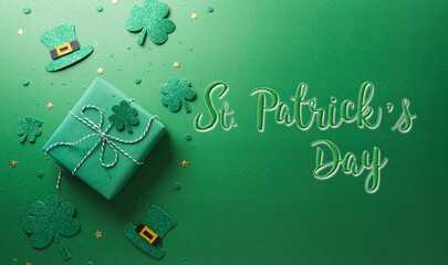 Wall Mural - Happy St Patrick's Day decoration concept made from shamrocks ( clover leaf), gift box and leprechaun hat on green background.