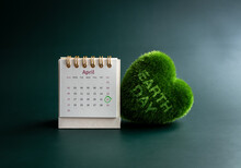 Earth Day Concept. Earth Day, Text On Green Heart And April 2023 Page Desk Calendar With Circle Mark On Day 22 On Green Background. Environment And Planet Protection. Happy Earth Day, 22 April.