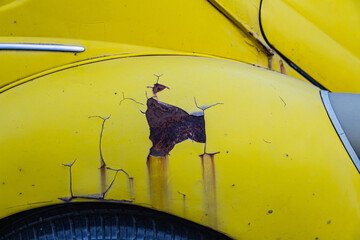 Detail light close up of on old vintage  car.  Yellow rusty car