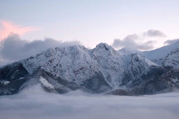 Poster - Winter scenery of panorama of Tatras Mountains with characteristic Giewont peak with cross, and clouds under them from Gubalowka hill in Zakopane, Podhale, Poland