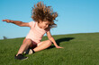 Kid falling down on the grass. Moment of the fall down. Little child tripped and falls down. Fall risk for children. The moment of the fall. Clumsy kid.