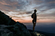 © Cavan Images - female hiker with headlamp hikes Katahdin at sunrise