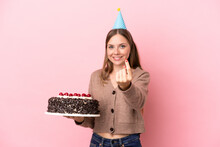 Young Lithuanian Woman Holding Birthday Cake Isolated On Pink Background Doing Coming Gesture