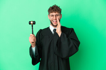 Canvas Print - Judge over isolated green background shouting with mouth wide open