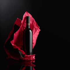 Wall Mural - Bottle of red wine on a black background..