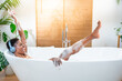© LiettaOraz - Stress-free weekend, overjoyed, relaxation and self care. Happy woman foam bathes listening music