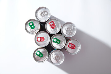 Colorful Drink Cans On white background, top view, hard light shadows, green and red pull tabs