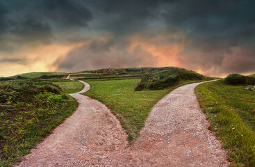 landscape of a fork in the road at storm weather, concept of insecurity of future