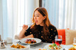 © Collab Media - Asian woman eating dish with fried potatoes and meat