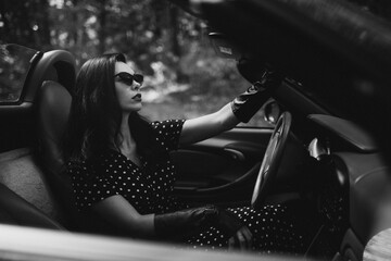 Beautiful woman driving red cabrio