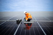 Top view of solar energy worker installing photovoltaic panels on the roof.