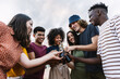 © Xavier Lorenzo - Young happy group of multi-ethnic friends celebrating together cheering with beer. Millennial diverse people enjoying summer party together on vacation. Friendship lifestyle concept