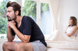 © Avirut S. - Young couple having problems with sex life. Couple quarreling and fighting in relationship at home. Relationship problems. Man sitting on the edge of the bed in bedroom.