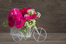 A Bicycle Toy With Flowers. The Concept Of Celebration. Copy Space. Holiday