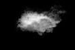 White powder explosion cloud against black background.White dust particle splash.