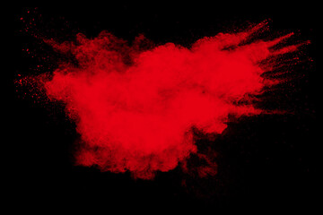 Wall Mural - Red powder explosion cloud on black background. Freeze motion of red color dust  particle splashing.