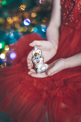 Wall Mural - Christmas toy on the Christmas tree bunny in the hands of a girl