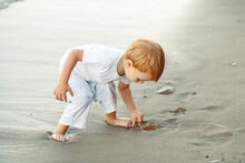 Child Playing On The Beach
