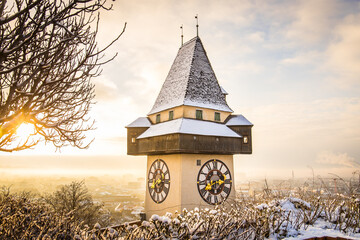 Sunrise at the Schloßberg landmark in Graz, Austria with the iconic clocktower and a dramatic sky