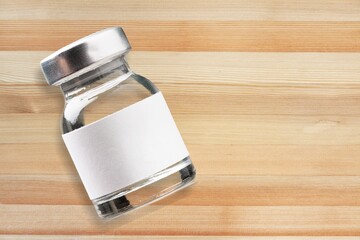 Poster - Glass medical bottle for treatment on the desk