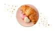 Fresh baked nut croissant and heart shape french cookies macarons macaroons with crumbs on vintage pink plate isolated on white background.