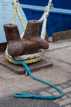 Old Rusted Metal Mooring Bollard With Different Coloured Roped Tied Around It At Camber Dock, Portsmouth, England.