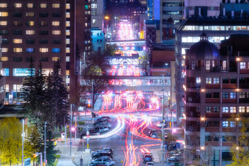 Wall Mural - View of the night city. Street and transport. Blurred car lights. Traffic. Wallpaper and background. Skyscrapers and business centers.