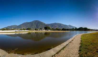 Panoramic view of a sunrise at Parque del Este with El Avila at the background