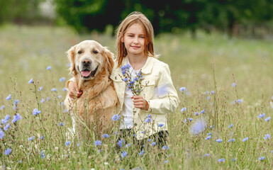 Wall Mural - Preteen girl with golden retriever outdoors