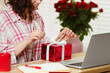 © New Africa - Valentine's day celebration in long distance relationship. Woman opening gift from her boyfriend indoors, closeup