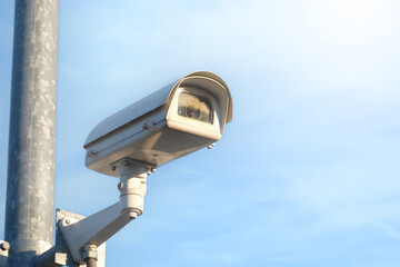 Modern public CCTV camera with clear sky background. Recording cameras for monitoring all day and night. Concept of surveillance and monitoring with copy space.