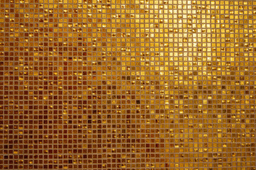 small gold tile texture. small golden tiles arranged to fit it into background. shiny golden mosaic 