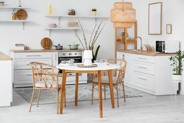 Wall Mural - Vase with willow branches on dining table in interior of kitchen