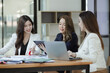 © SOMKID - Group of young Asian business woman teamwork and presenting new projects in the office.