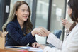 © SOMKID - Business woman handshake, Concept of business partnership meeting.